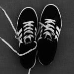 Black and white sneakers against a gray background.