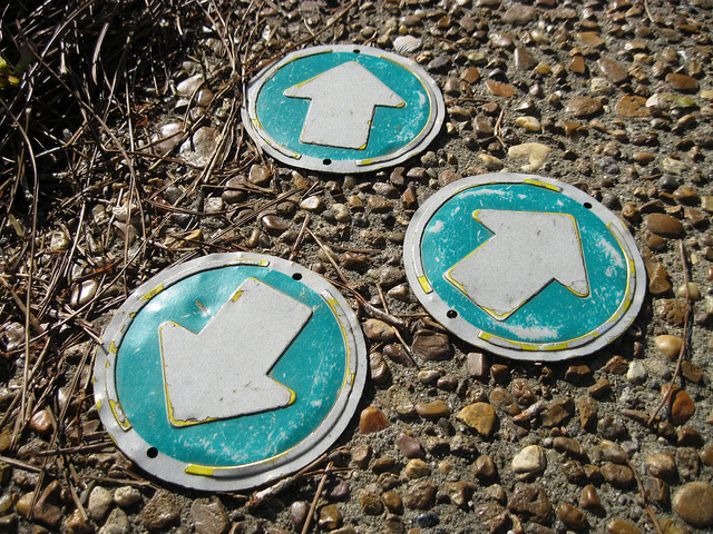 Photograph of three arrows pointing in different directions, represents the process of making your final decision.