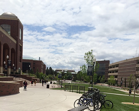 Students walking in University of Nevada, Reno campus with bicycle racks.