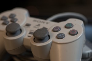 Close-up shot of a gray Sony Playstation game controller.
