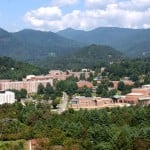 Western Carolina University campus from afar. Surrounded with trees and mountains on the background.