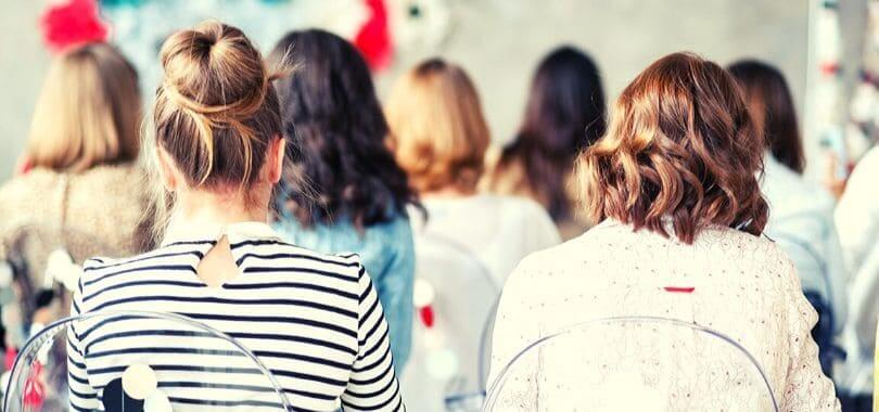 A room full of women with their backs toward the camera.