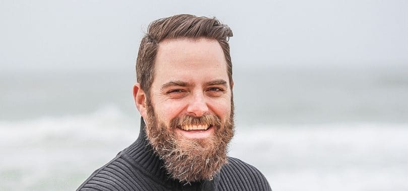 A middle-aged adult smiling.