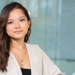 A business person sitting and looking towards the camera.