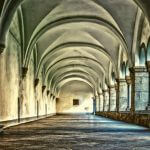 An empty hallway inside of a monastery.