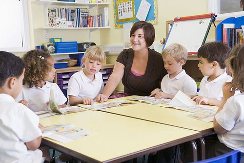 students-in-class-with-teacher-reading by www.ilmicrofono.it classroom chalk board photo