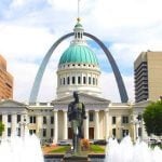 The Gateway Arches with a capital building in front of it.