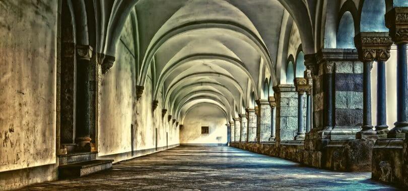 An empty hallway inside of a monastery.