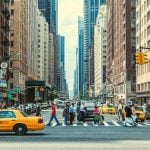 Downtown New York with people crossing a street.