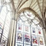 Stained glass windows with sunlight streaming through them.