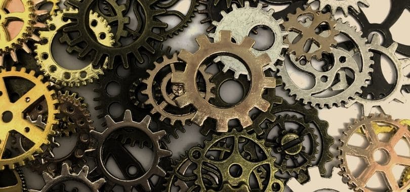 Different sizes and colors of gears in a pile.