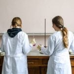 Two scientists standing with their backs to the camera.