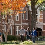 3 students walking through University of Central Arkansas campus.