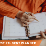 A college student writing down assignment due dates in her monthly planner.