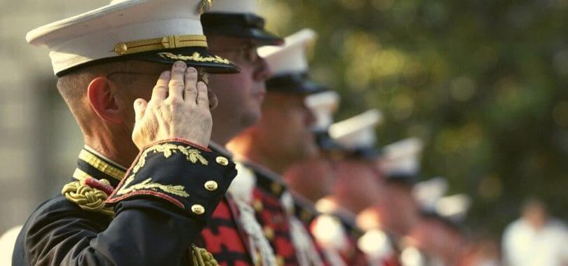 Military personnel saluting.