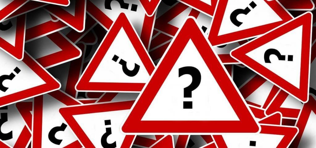 Red and white signs with a black question mark in the middle.