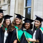 Five graduate female students posing for a picture taking.