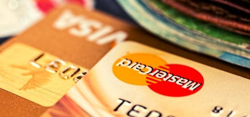 A close-up of two gold credit cards.