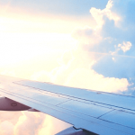 The wing of an airplane against a sunset.