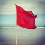 A red flag on the sea side.