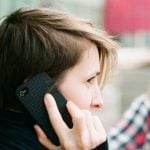 Student holding a cellphone to their ear.