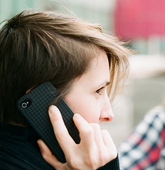 Student holding a cellphone to their ear.