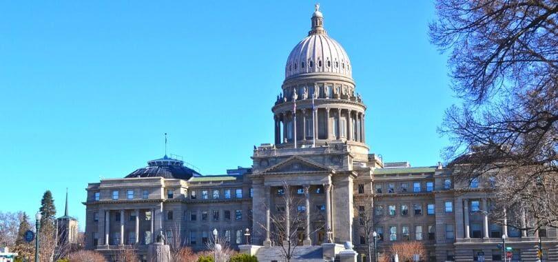 A grey brick building with a dome top.