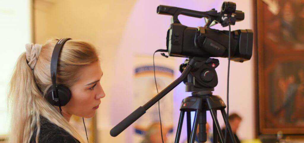 College student standing in front of a camera.