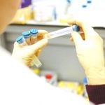 A scientist holding a test tube in their hands.