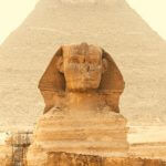 The Sphinx with a pyramid behind it.