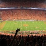 Clemson stadium with thousands of people cheering for a football game.