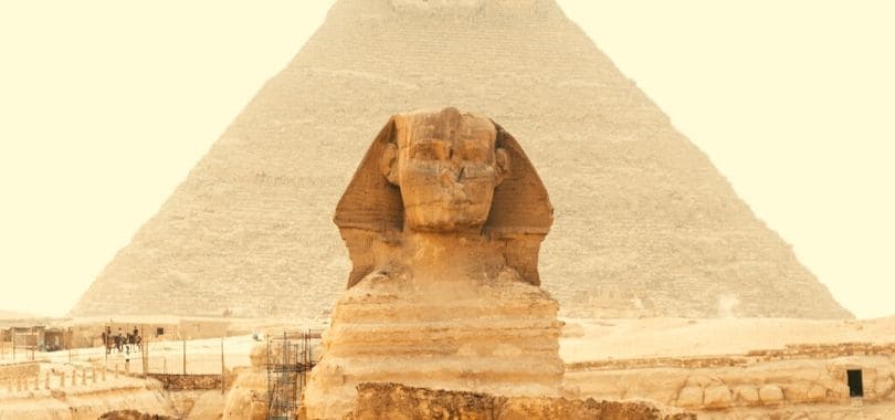 The Sphinx with a pyramid behind it.