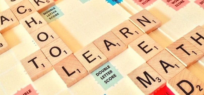 Scrabble tiles that spell "school," "learn," and "math."