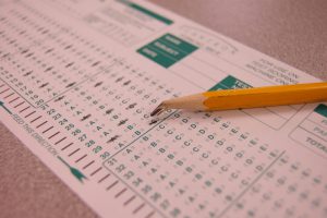 Scantron answer sheet with shaded answers and a broken pencil.