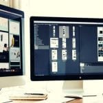 Two computer monitors on a white desk.