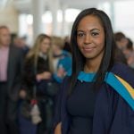 A graduate student smiling and posing for a photo.