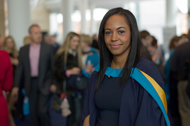 A graduate student smiling and posing for a photo.
