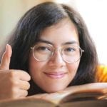 A student giving a thumbs up to the camera.