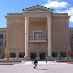 Student walking infront of West Texas A&M University old main building.