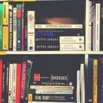Rows of sociology books on bookshelves.
