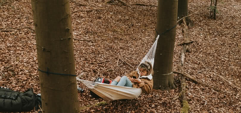 Student leaning in a hammock.