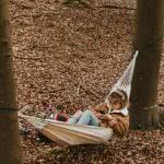 Student leaning in a hammock.