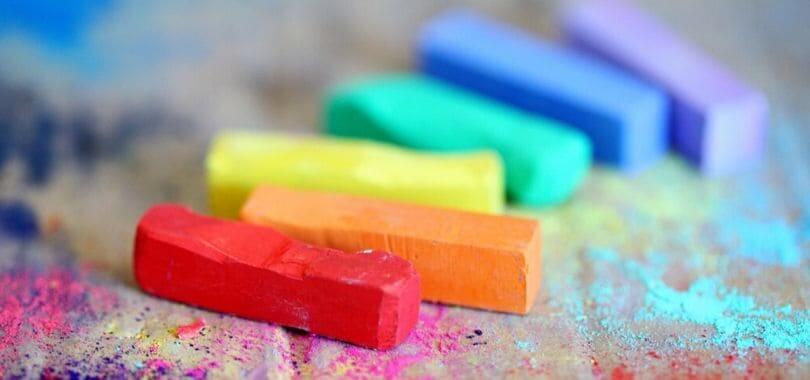 Colorful pieces of chalk on a sidewalk.
