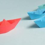 Pink, blue and green origami boats.