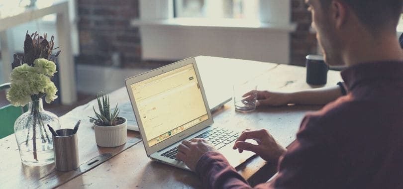 A college student sitting in front of a laptop.