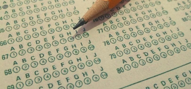 A pencil laying on a Scranton sheet.