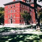 Red building on a college campus.