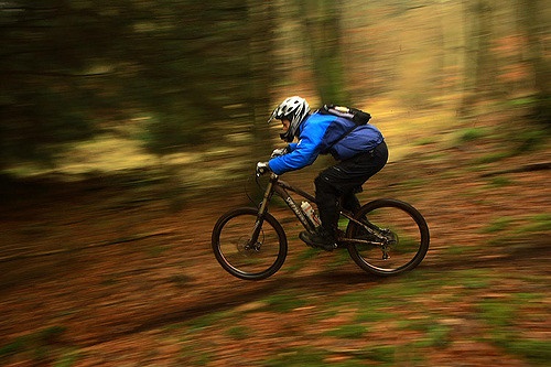 A person is riding a bicycle at a fast speed.
