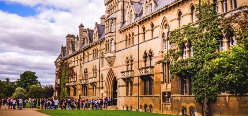 Students on a campus tour, lining up to go into a campus building.