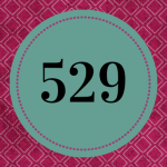 A purple background with a dark green circle, with the number 529 in the center.
